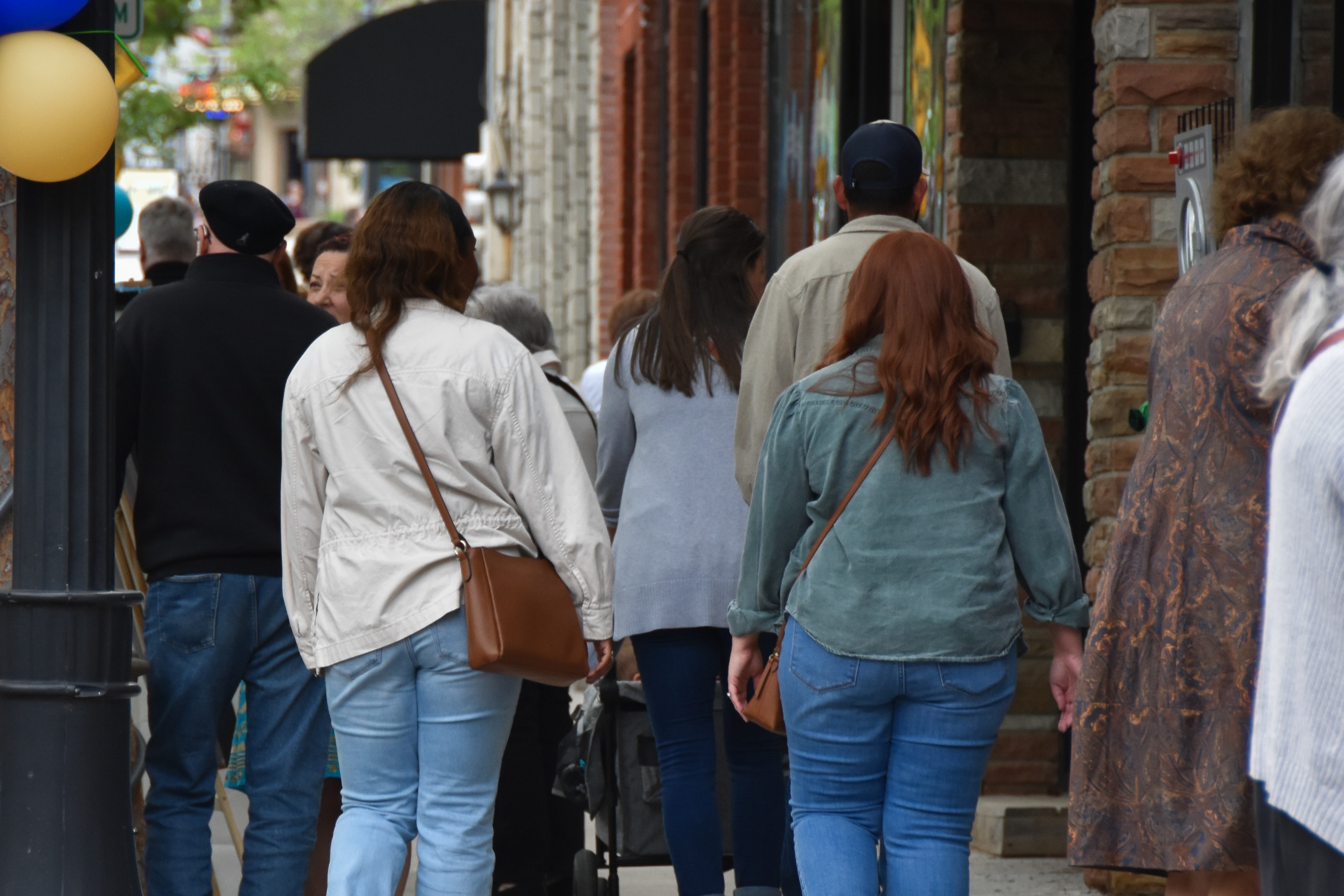 group of people walking in downtown lee's summit