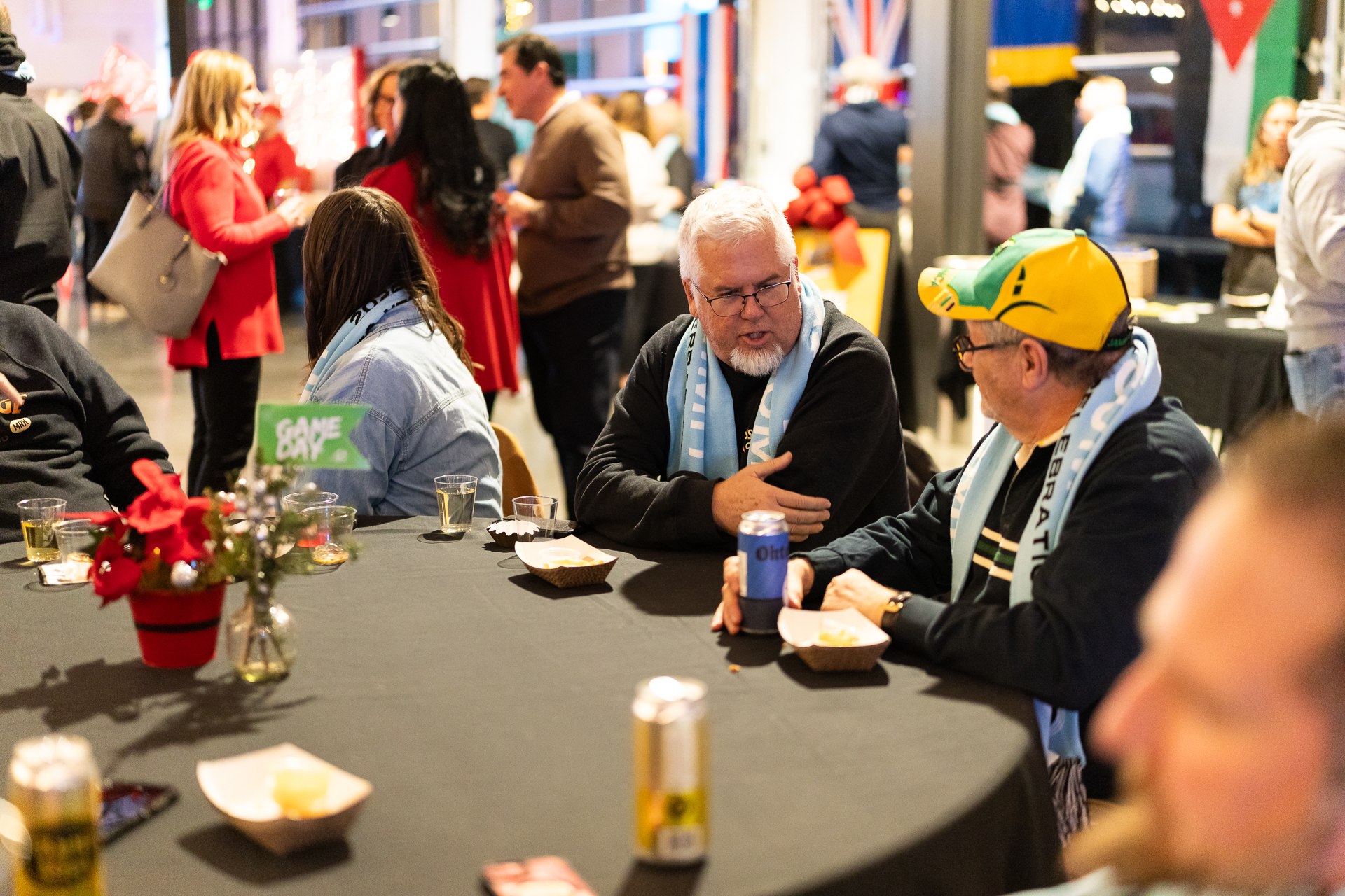 People in soccer apparel at a table talking